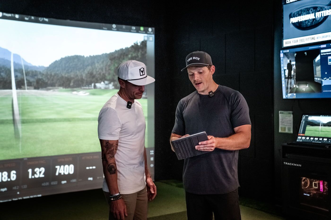 A Tee Box pro reviewing performance data with a golfer - our Tucson golf lesson prices support a complete development plan, not just a single lesson.