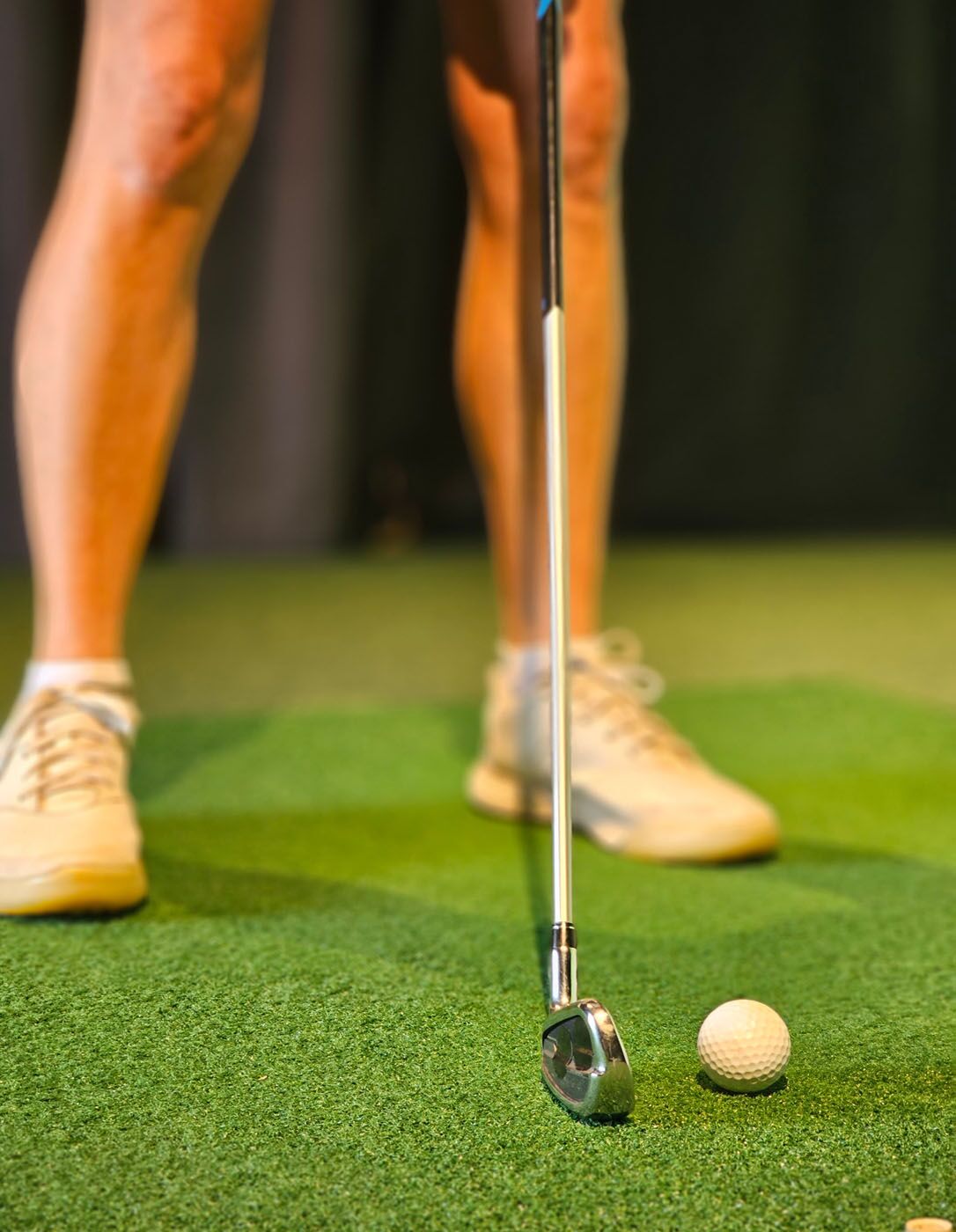An image of a golf ball and club lined up for a hit at Tee Box Oro Valley.