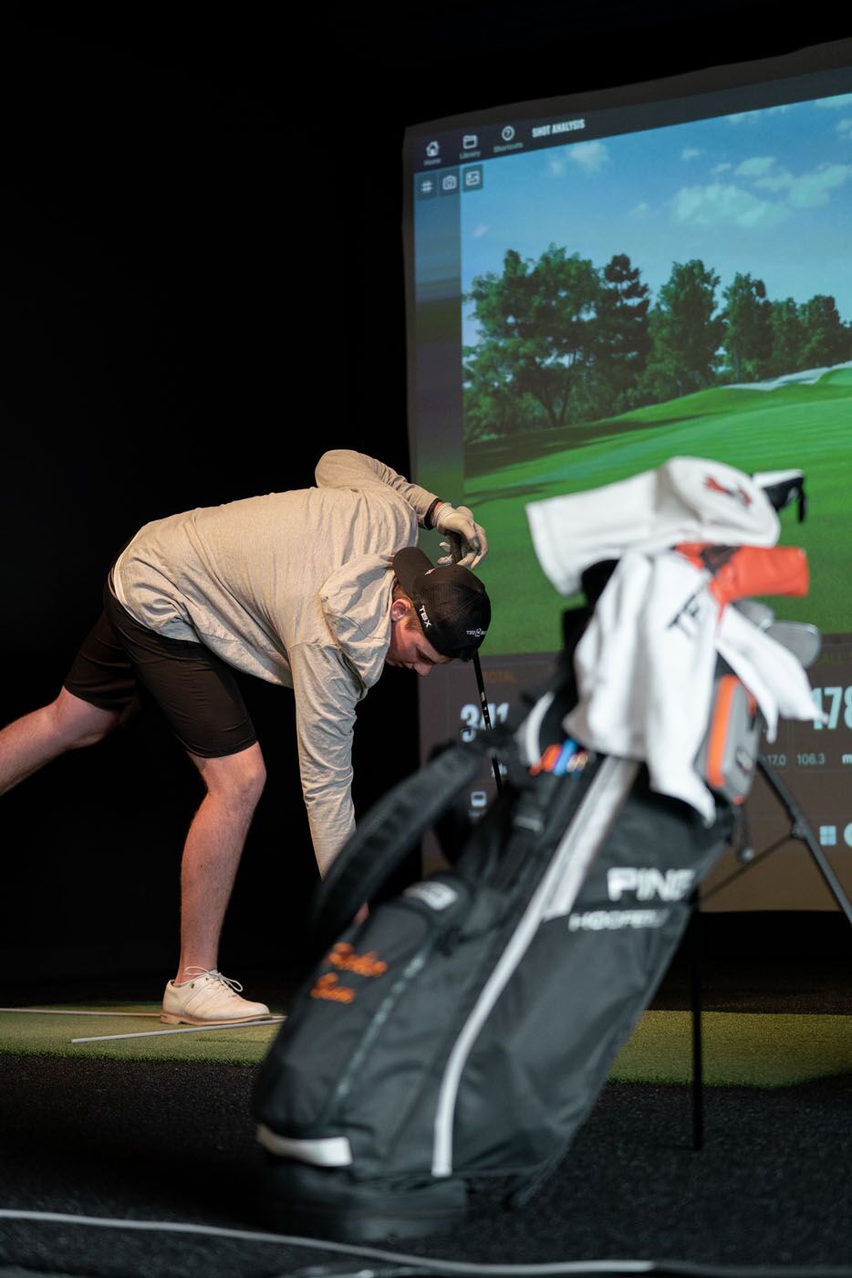 A golfer using our simulators with a golf bag in Scottsdale, AZ.