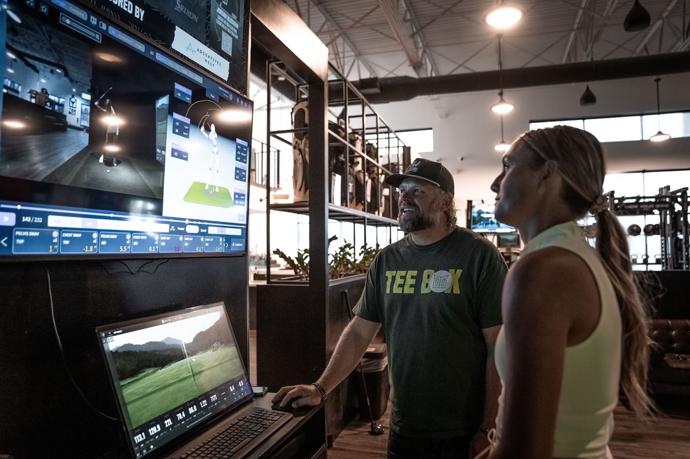 A Tee Box pro using sportsbox ai in Delray Beach, FL and showing the data to a golfer.