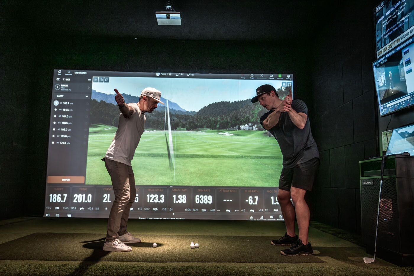 A Tee Box Pro helping a member adjust their swing based on data from TrackMan in Delray Beach, FL.