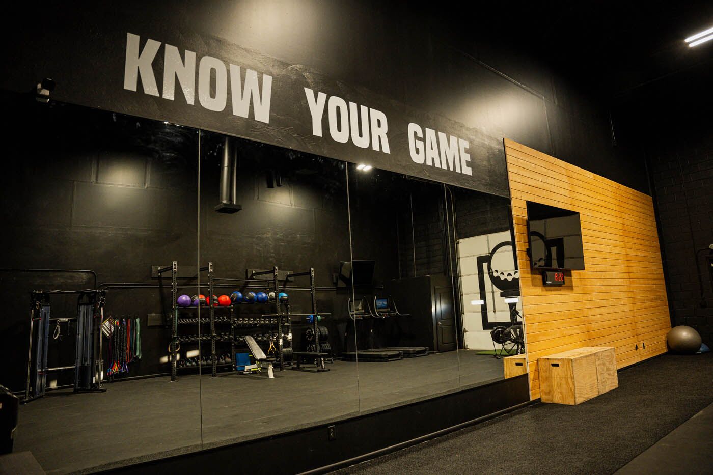 Tee Box St. George gym mirrors with motto.