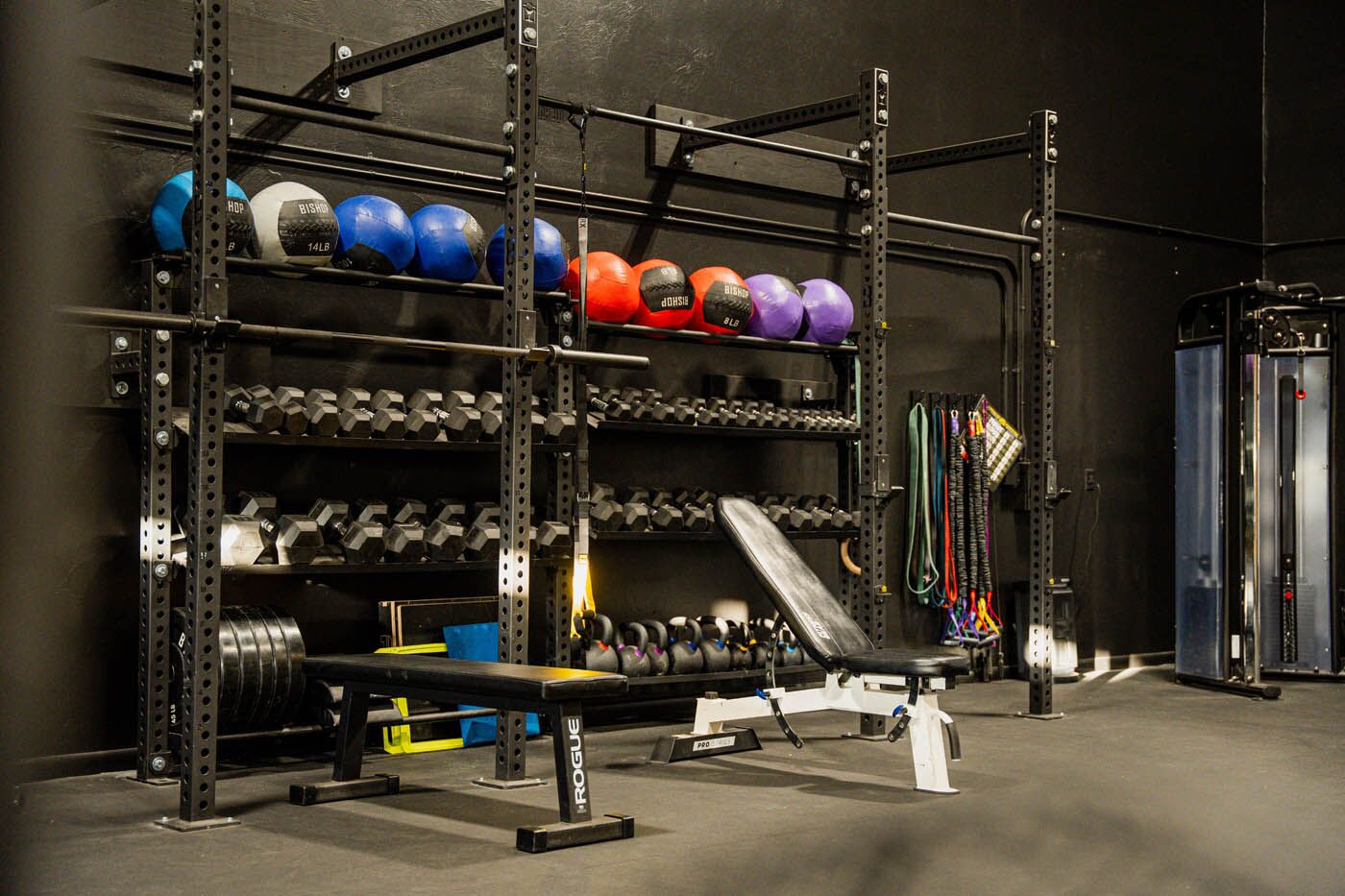 Tee Box St. George gym equipment with bench and pull-up bars.