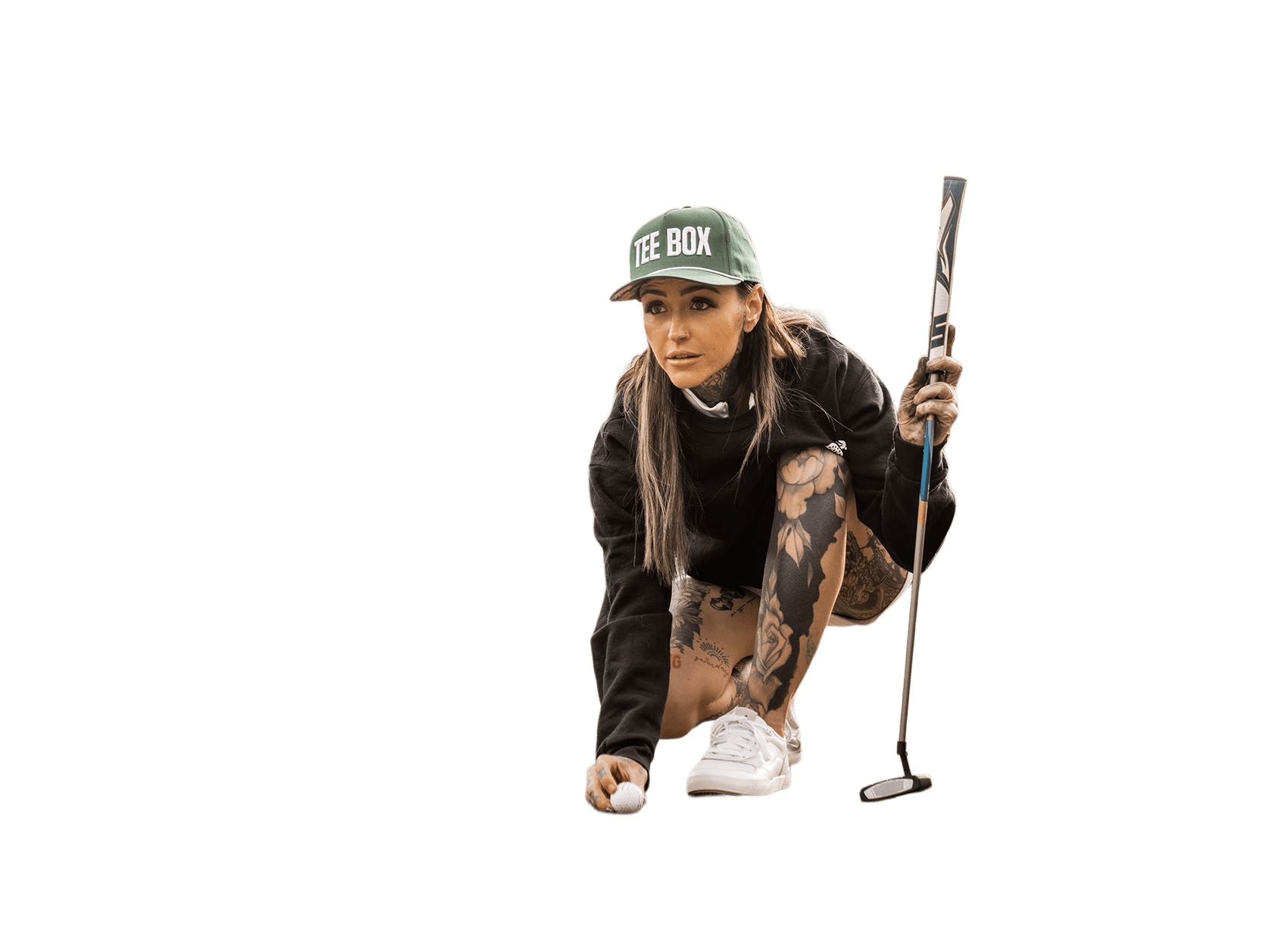 An image of golfer Taylor Nicole lining up a shot on a green.