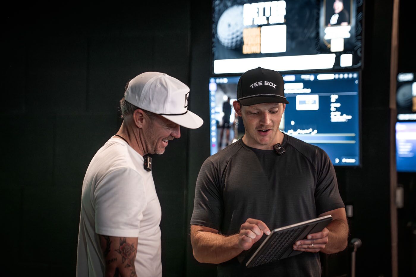 A Tee Box Pro and golfer analyzing data from our indoor virtual golf in Fort Lauderdale, FL.