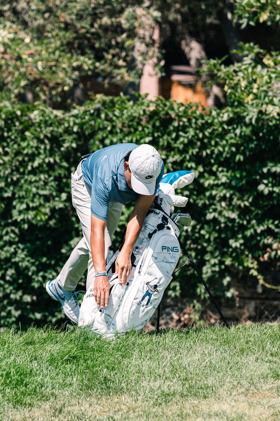 An image of a golfer bending over their custom golf bag - for Pleasant Grove fitted golf clubs, contact Tee Box.