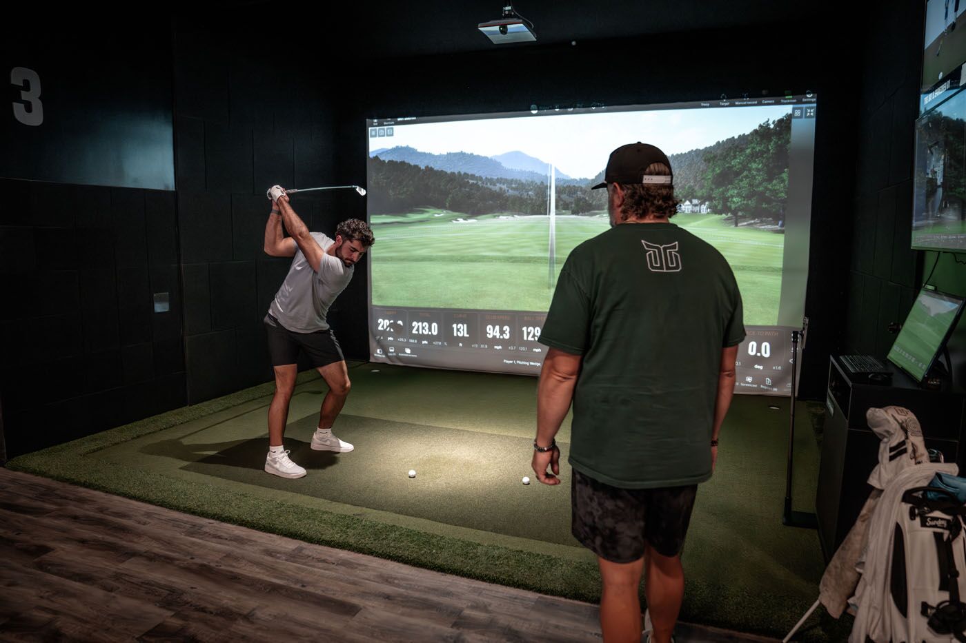 A man using TrackMan Technology at a Tee Box location during golf lessons for adults in Pleasant Grove, UT.