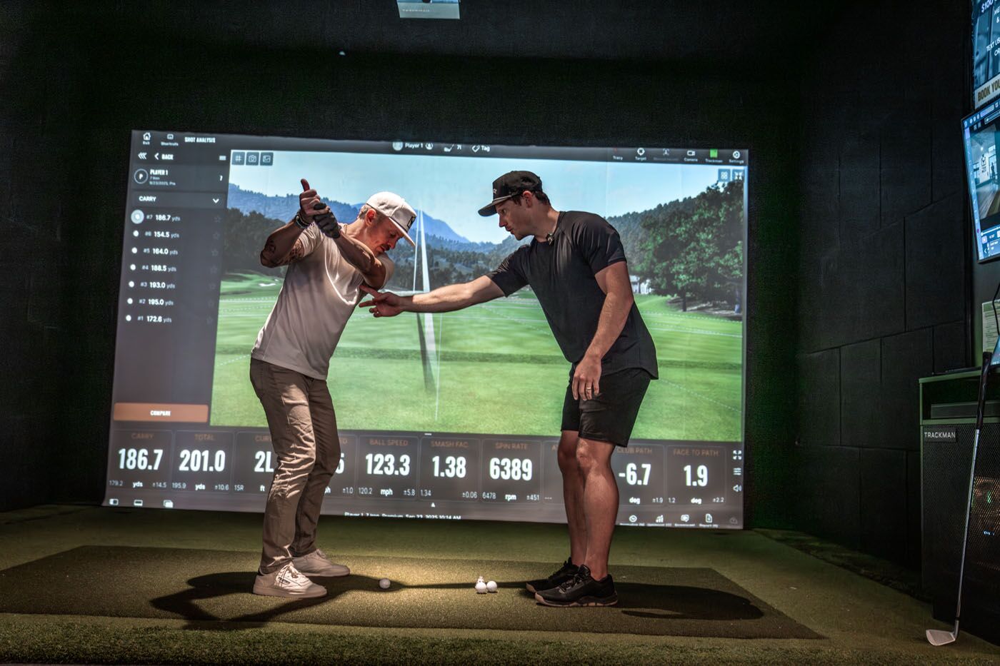A Tee Box Pro conducting a performance assessment with a golfer.