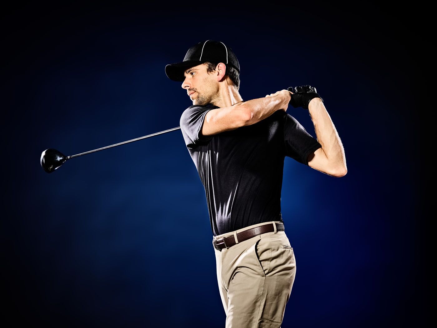 An image of a golfer hitting their club at Tee Box Central Houston.